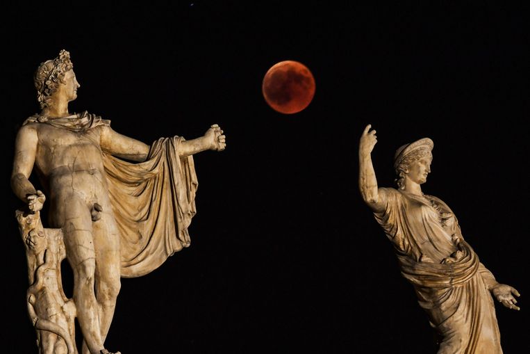 De bloedmaan gisteravond tussen standbeelden van de Griekse goden Hera en Apollo in het centrum van Athene. 